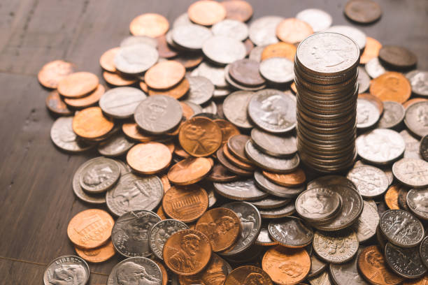 A picture of a stack of U.S. coins arranged in descending size, highlighting their edges and metallic sheen